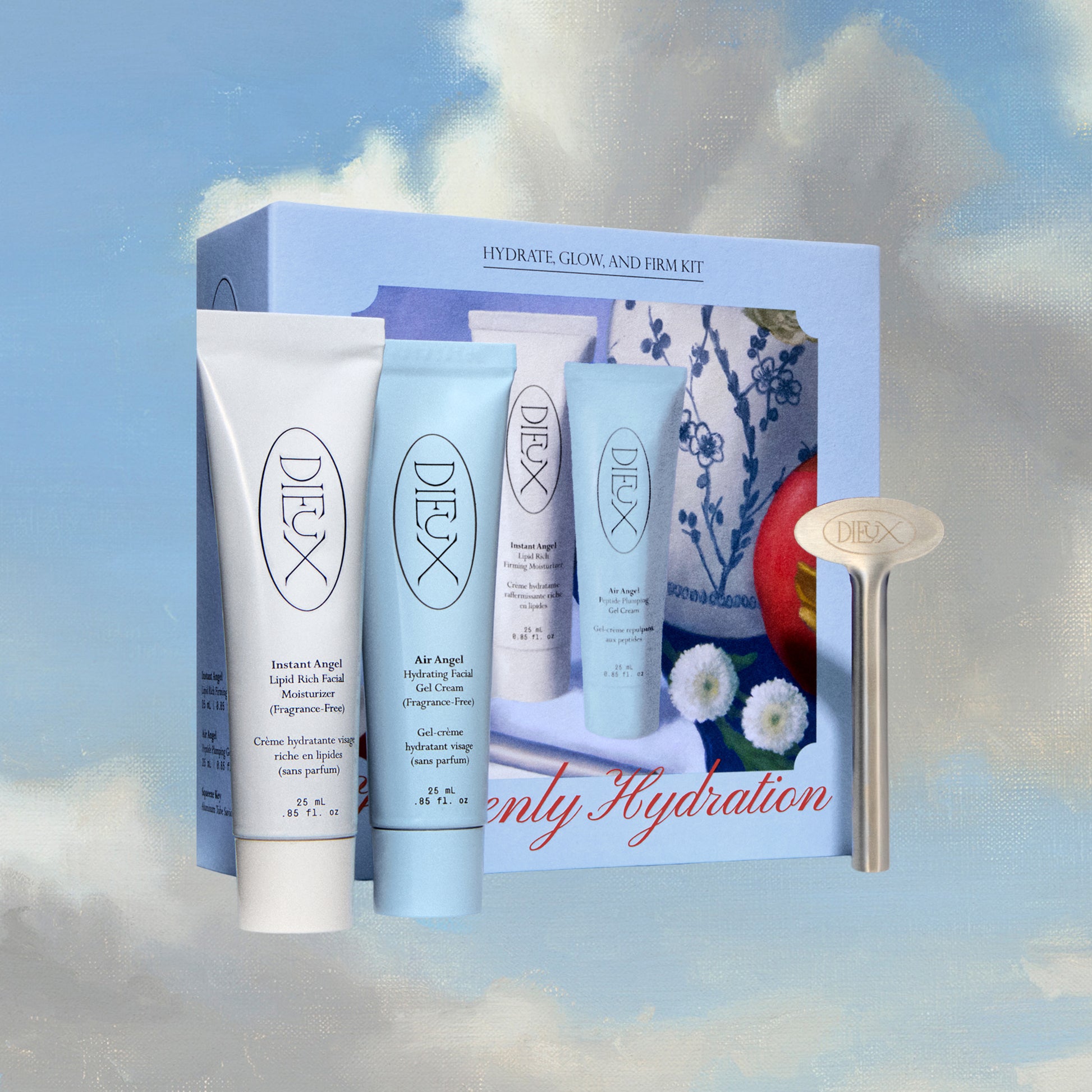 Dieux Heavenly Hydration Set on a blue and white cloud background. Features the box the set comes in and the three products: Instant Angel Moisturizer 25ml, Air Angel Gel Cream 25ml, and Squeeze Key.