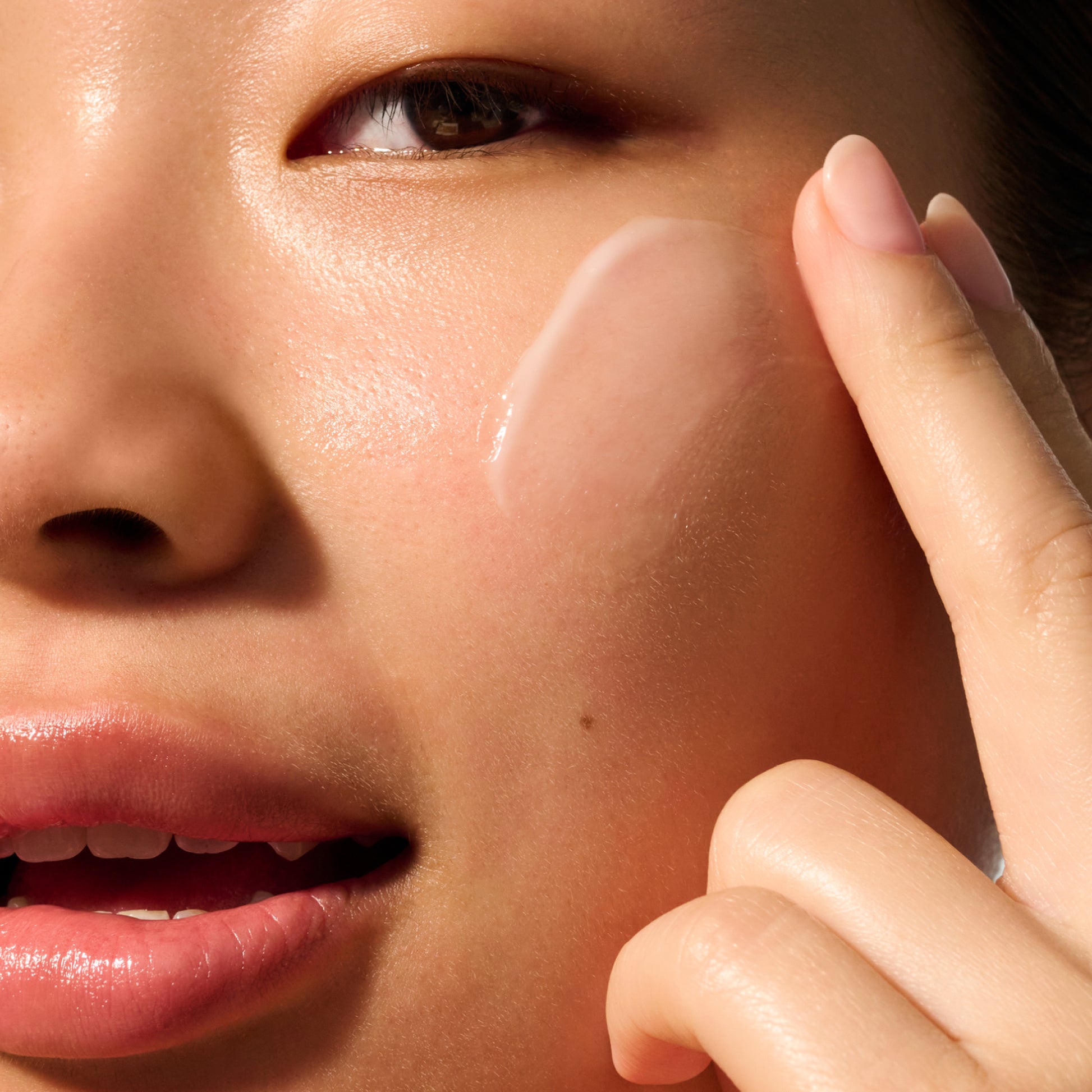 image of a model with a swipe of Dieux Air Angel Gel Cream on her face.