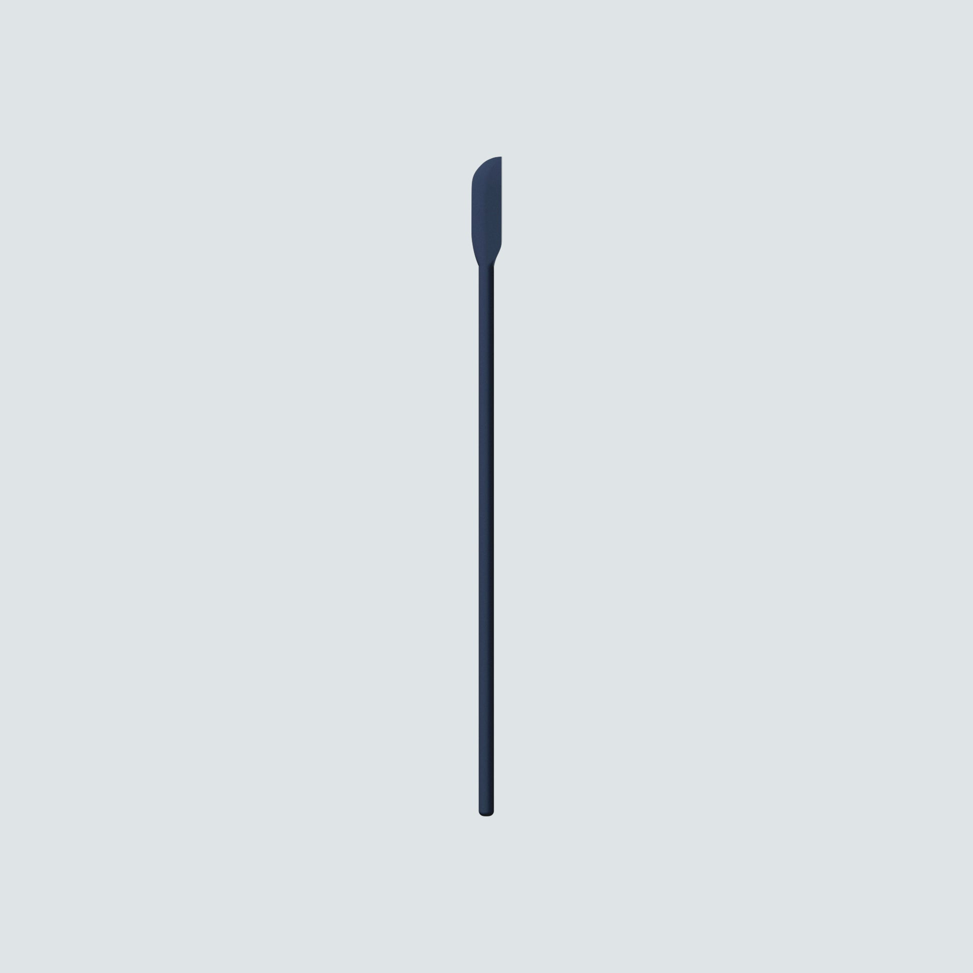 Dieux Skincare Scraper, a dark blue silicone spatula, on a light gray background