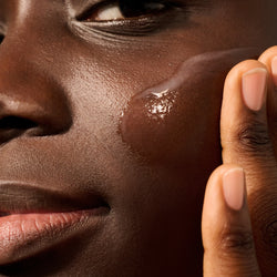 Model with a swatch of Dieux Deliverance Serum on their face
