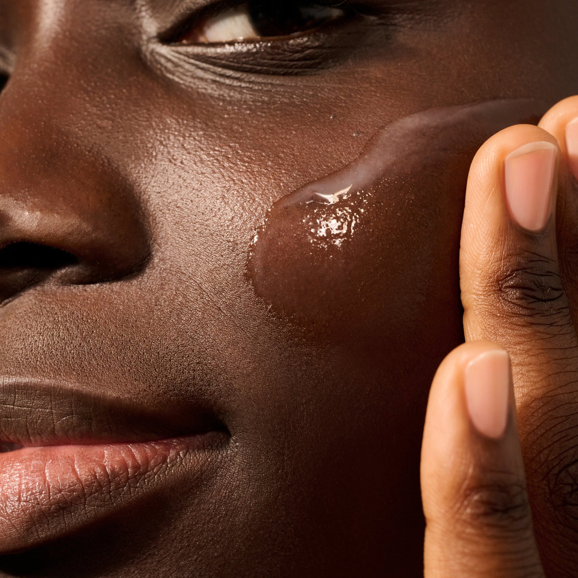 Model with a swatch of Dieux Deliverance Serum on their face