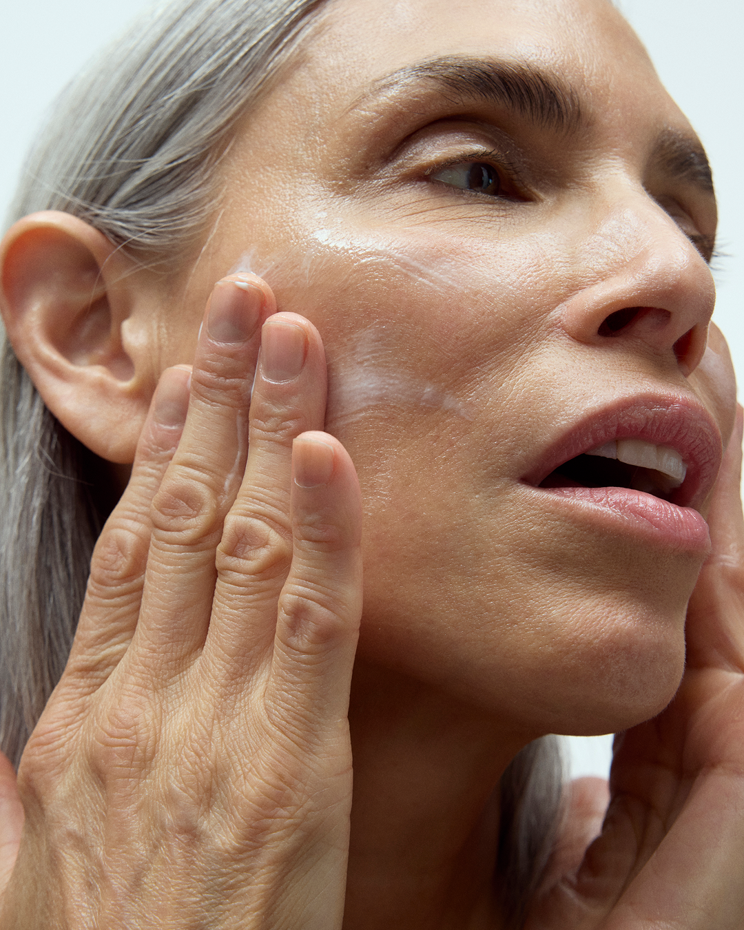 Person applying Instant Angel moisturizer to their face