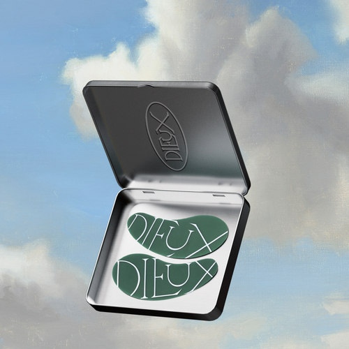 Dieux Forever Eye Mask in their tin on a blue and white cloud background.